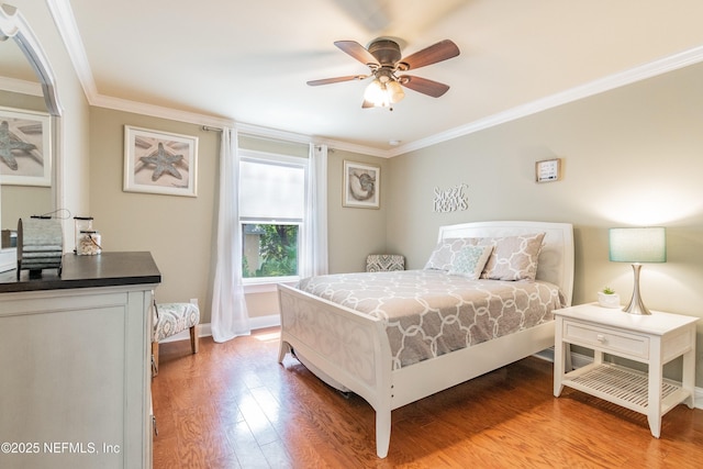 bedroom featuring crown molding, ceiling fan, and light hardwood / wood-style flooring