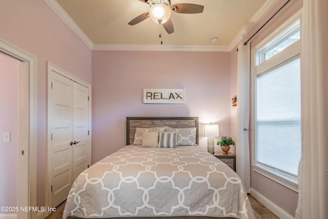 bedroom with ceiling fan, ornamental molding, and hardwood / wood-style flooring