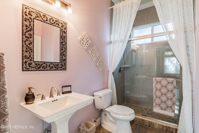 bathroom featuring sink, toilet, and walk in shower