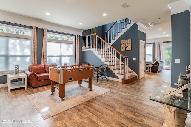 rec room featuring light hardwood / wood-style flooring and crown molding