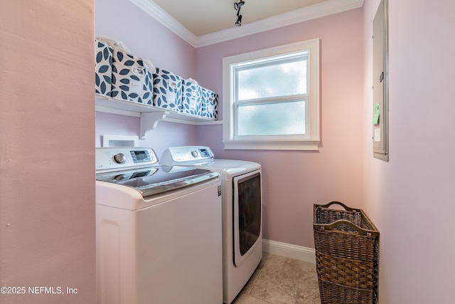 clothes washing area with independent washer and dryer and ornamental molding