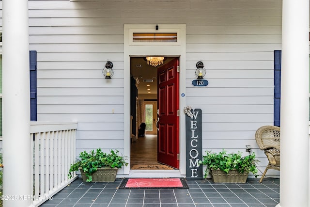 view of exterior entry featuring covered porch