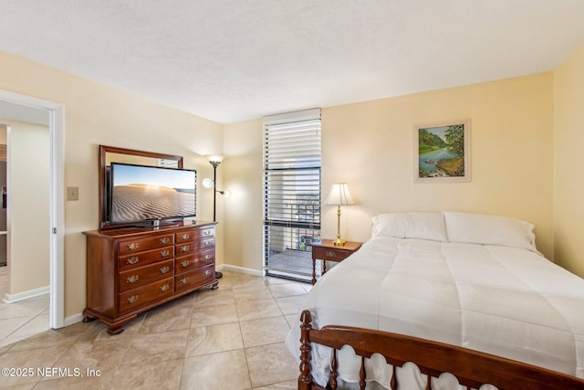 bedroom with light tile patterned flooring and access to exterior