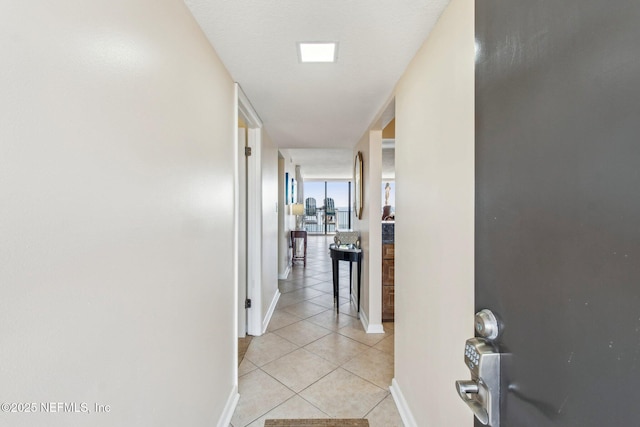 hallway featuring light tile patterned flooring