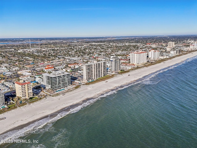 birds eye view of property with a view of the beach and a water view