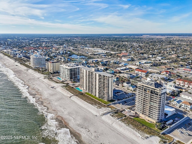 drone / aerial view featuring a view of the beach and a water view