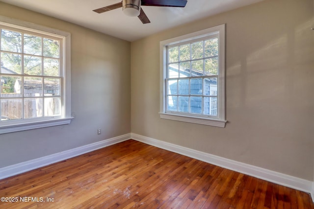 empty room with hardwood / wood-style floors and ceiling fan