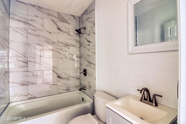 full bathroom with vanity, tiled shower / bath combo, and toilet