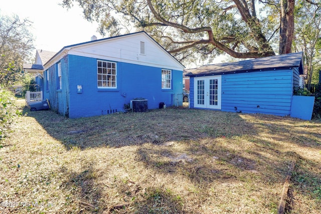 rear view of house featuring central AC and french doors