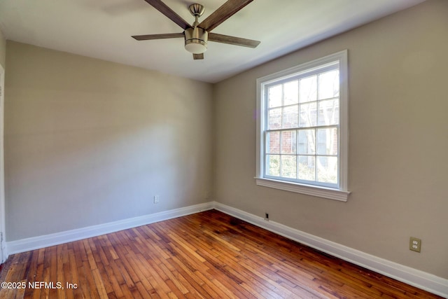 spare room with ceiling fan and wood-type flooring