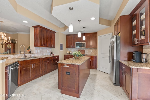 kitchen with decorative backsplash, appliances with stainless steel finishes, a center island, and pendant lighting