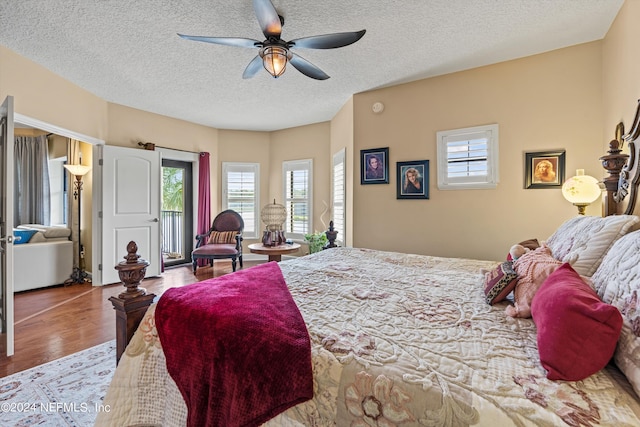 bedroom featuring ceiling fan, light hardwood / wood-style flooring, and a textured ceiling