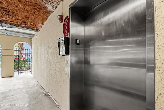 interior details with concrete flooring and elevator