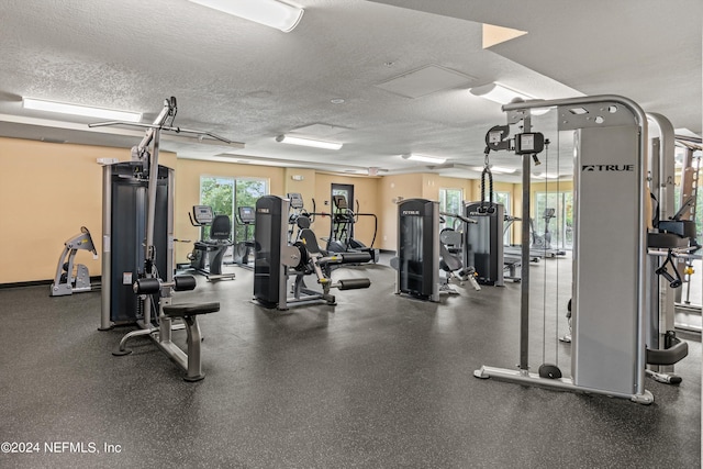 gym featuring a textured ceiling