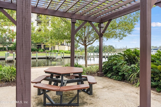 view of patio / terrace with a pergola, a water view, and a boat dock