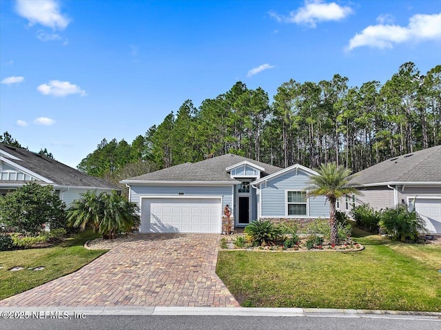 ranch-style house with a garage and a front lawn