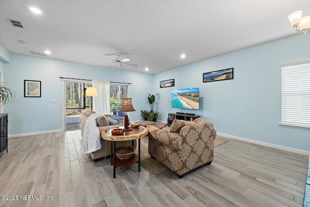 living room featuring ceiling fan and light wood-type flooring