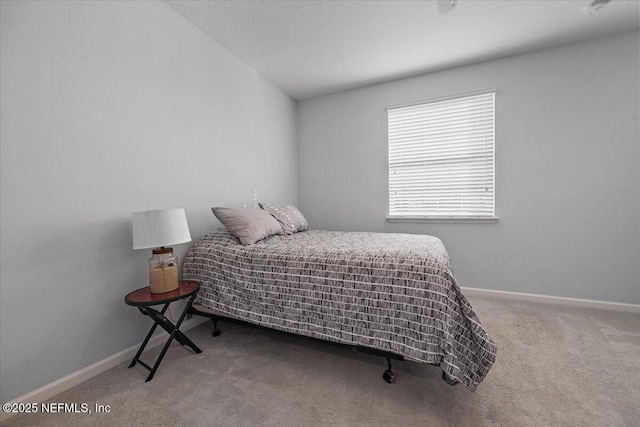 carpeted bedroom featuring lofted ceiling