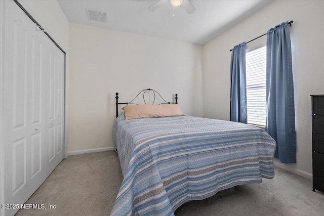 carpeted bedroom with ceiling fan and a closet