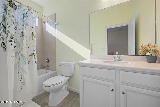 full bathroom with hardwood / wood-style floors, vanity, shower / bath combo, and toilet