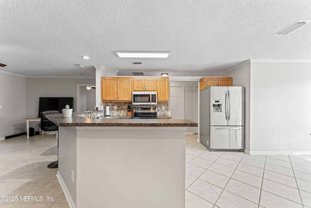 kitchen with sink, backsplash, stainless steel appliances, ornamental molding, and light tile patterned flooring