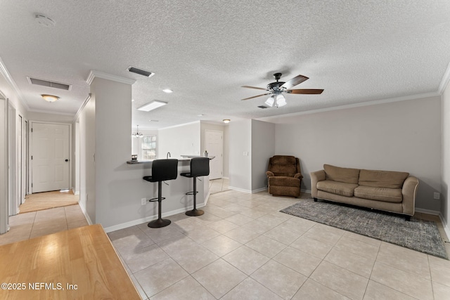 living room with crown molding, a textured ceiling, ceiling fan, and light tile patterned flooring