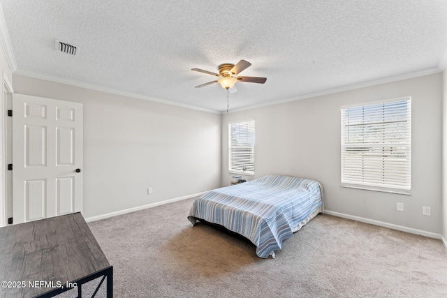 carpeted bedroom featuring ceiling fan, ornamental molding, and a textured ceiling