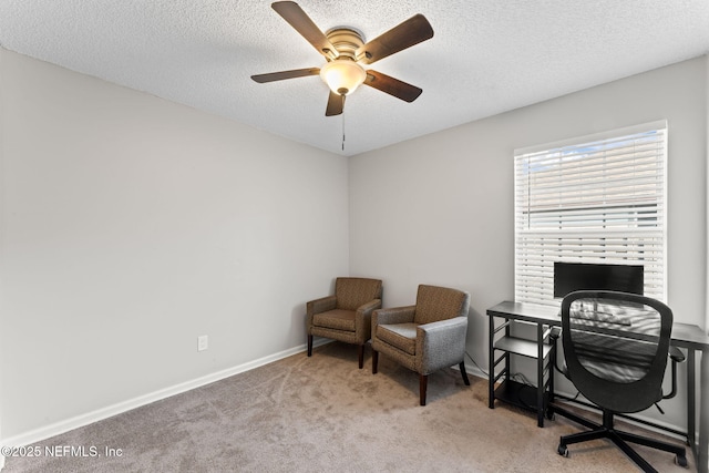 carpeted office featuring ceiling fan and a textured ceiling