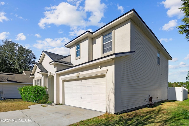 view of home's exterior with a garage and a yard