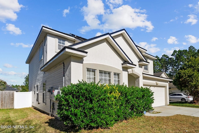 view of front facade featuring a garage and a front lawn