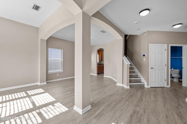 interior space featuring a textured ceiling and light hardwood / wood-style floors