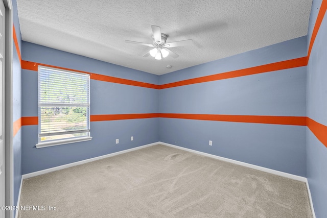 carpeted spare room featuring ceiling fan and a textured ceiling