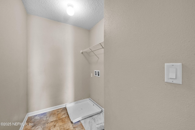 laundry area featuring a textured ceiling and hookup for a washing machine