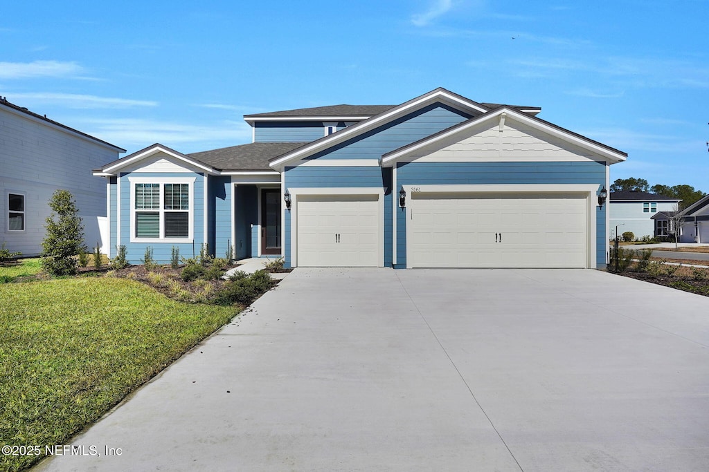 view of front facade with a garage and a front lawn