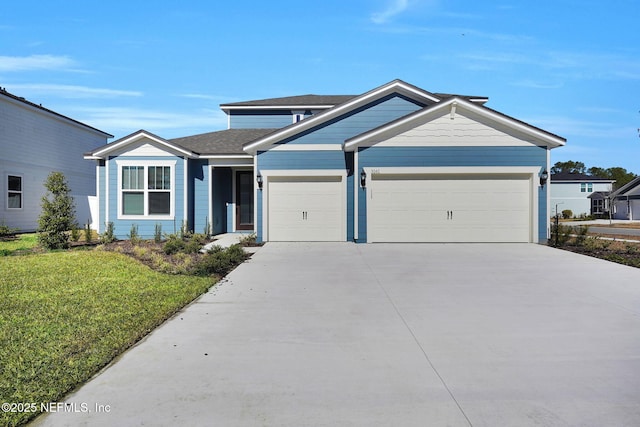 view of front facade with a garage and a front lawn