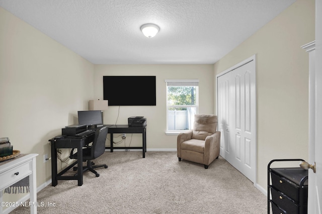 office with light carpet and a textured ceiling