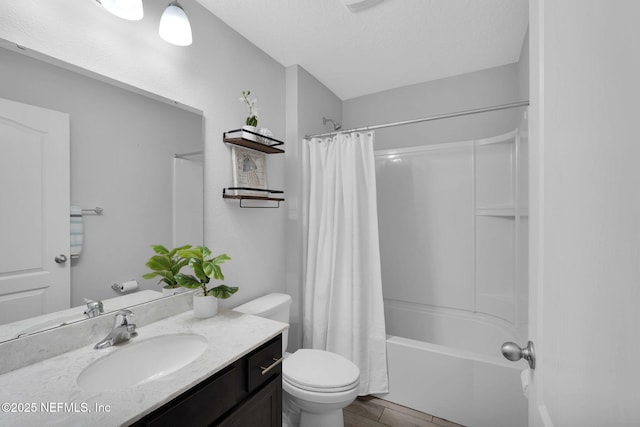 full bathroom with vanity, a textured ceiling, shower / bathtub combination with curtain, hardwood / wood-style floors, and toilet