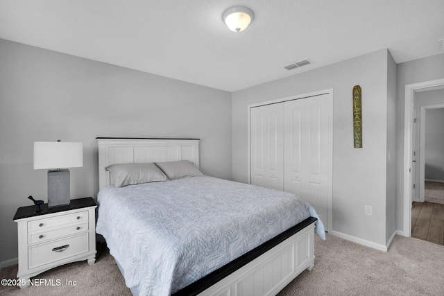 bedroom with a closet and light colored carpet