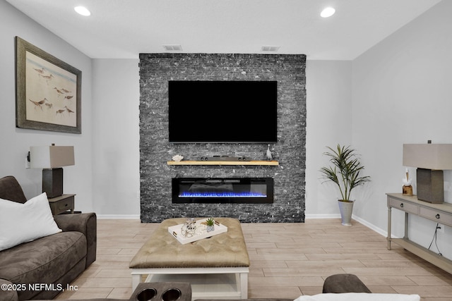 living room featuring hardwood / wood-style flooring and a fireplace