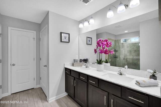 bathroom featuring vanity and an enclosed shower