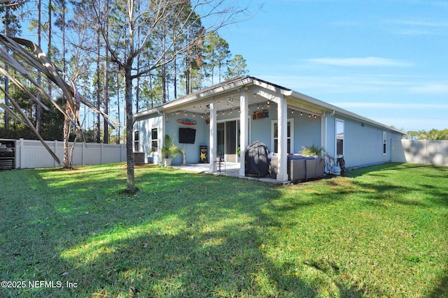 rear view of house with a patio area and a yard