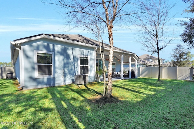 back of property featuring a yard and a patio