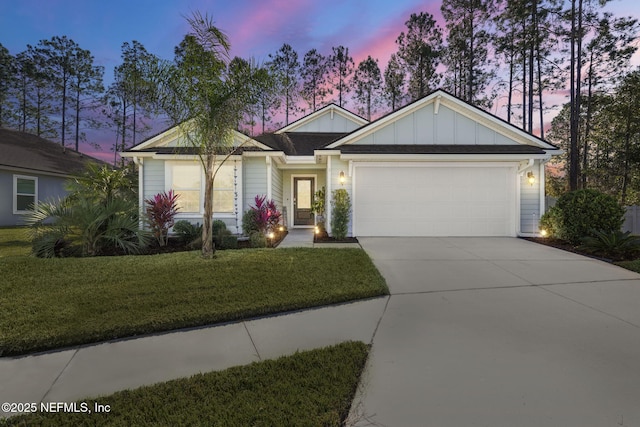 view of front of home featuring a yard and a garage