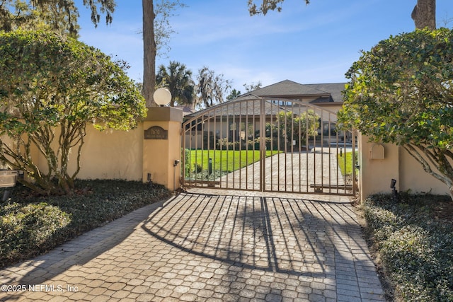 view of gate featuring a yard