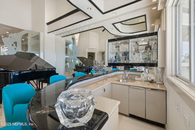 interior space featuring sink and white cabinetry