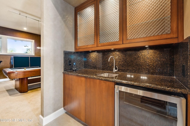 bar featuring wine cooler, backsplash, dark stone countertops, sink, and pool table