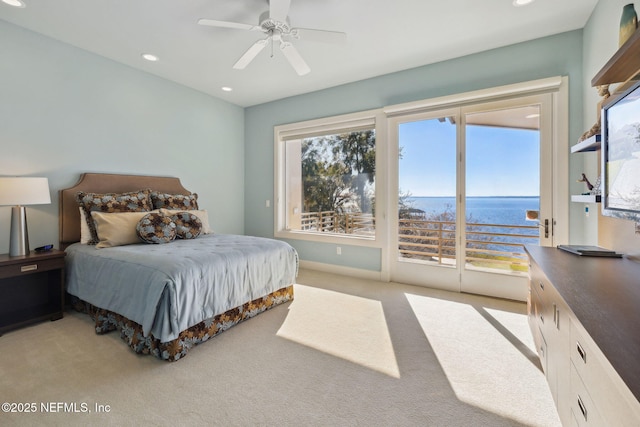 bedroom with light carpet, ceiling fan, access to exterior, and multiple windows