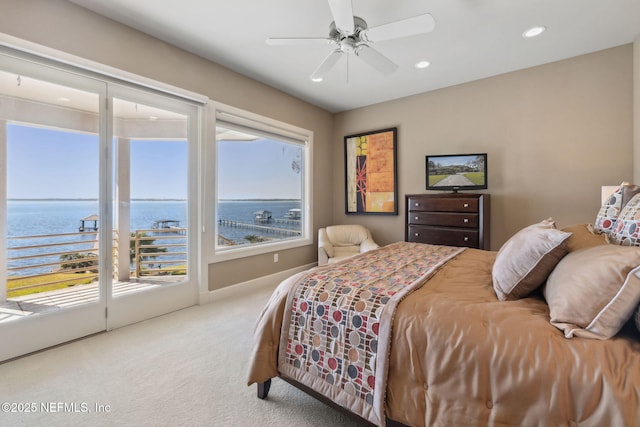 bedroom featuring ceiling fan, carpet, a water view, and access to outside