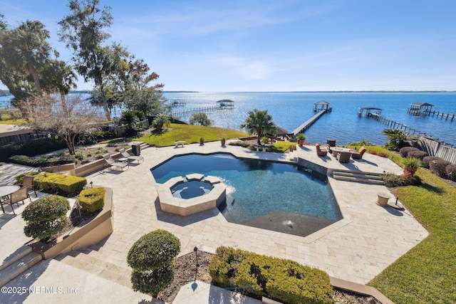 view of pool featuring an outdoor fire pit, a patio area, a water view, and an in ground hot tub