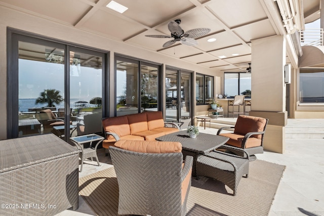 view of patio / terrace featuring an outdoor hangout area, ceiling fan, and a water view